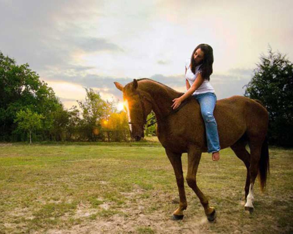 Denver wedding photographer Lauren Holmes riding a horse bare back.